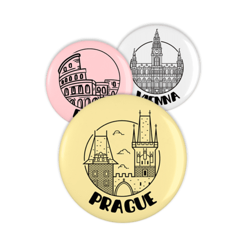Tres imanes de nevera redondos con ilustraciones de destinos famosos: Prague en amarillo, Rome en rosa y Vienna en blanco.